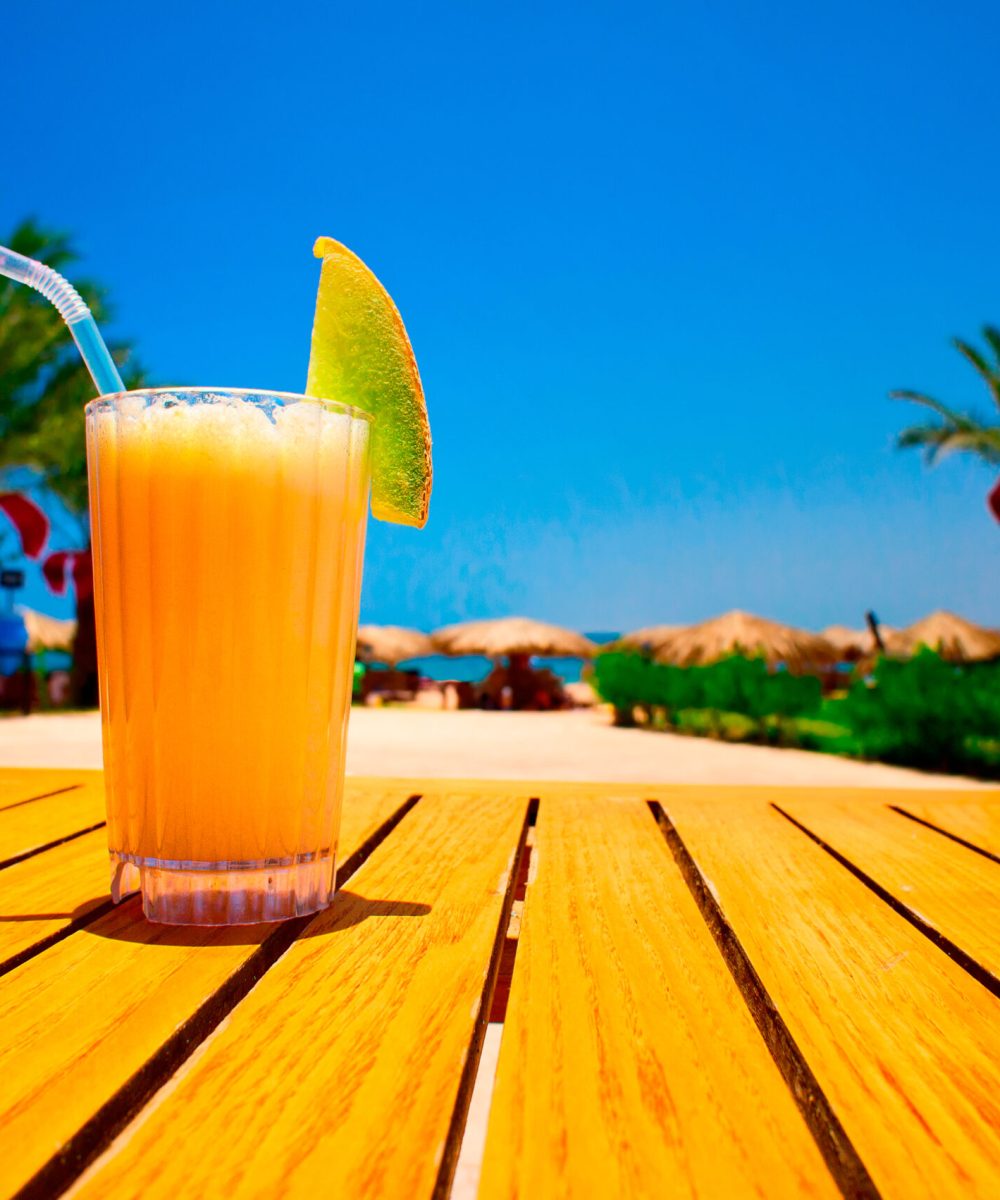 Glass,Of,Tasty,Juice,With,Pipe,On,The,Table,Next