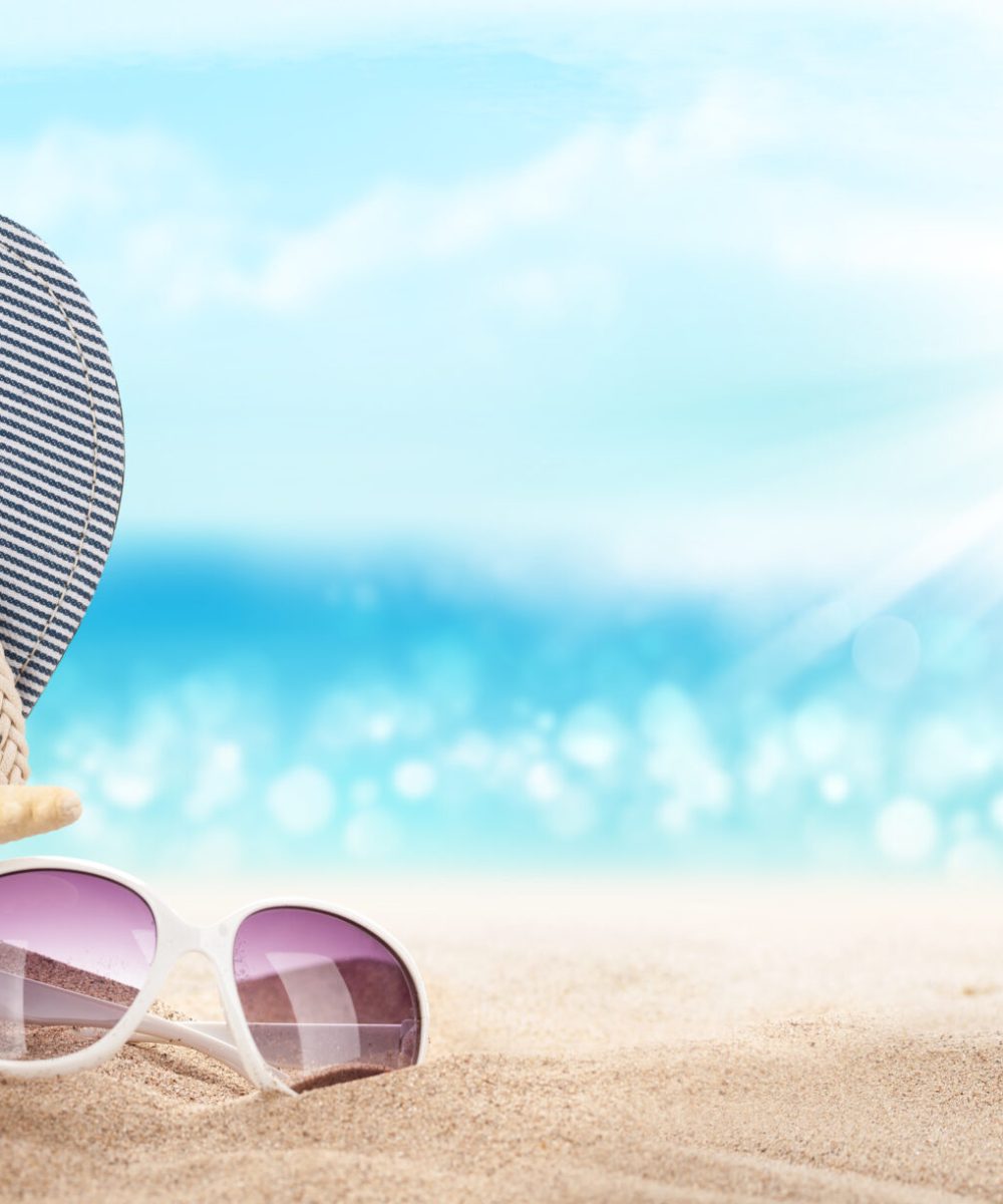 Flip,Flops,,Starfish,And,Sunglasses,On,Sunny,Sea,Beach,With